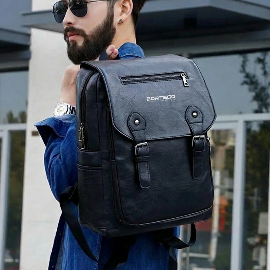 Man wearing a black backpack with 'Bortego' branding outdoors.