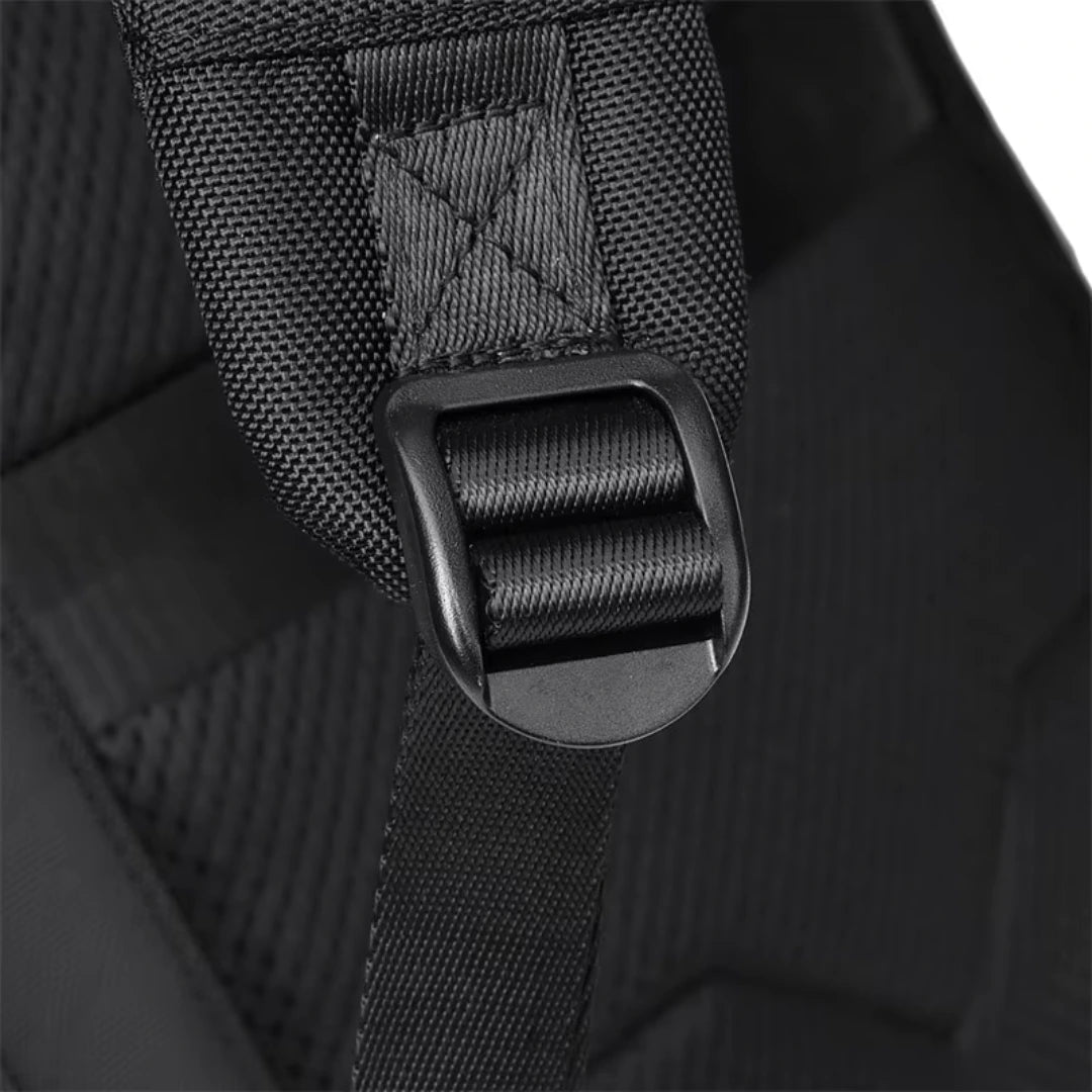 Close-up of a black backpack strap with buckle on a dark background