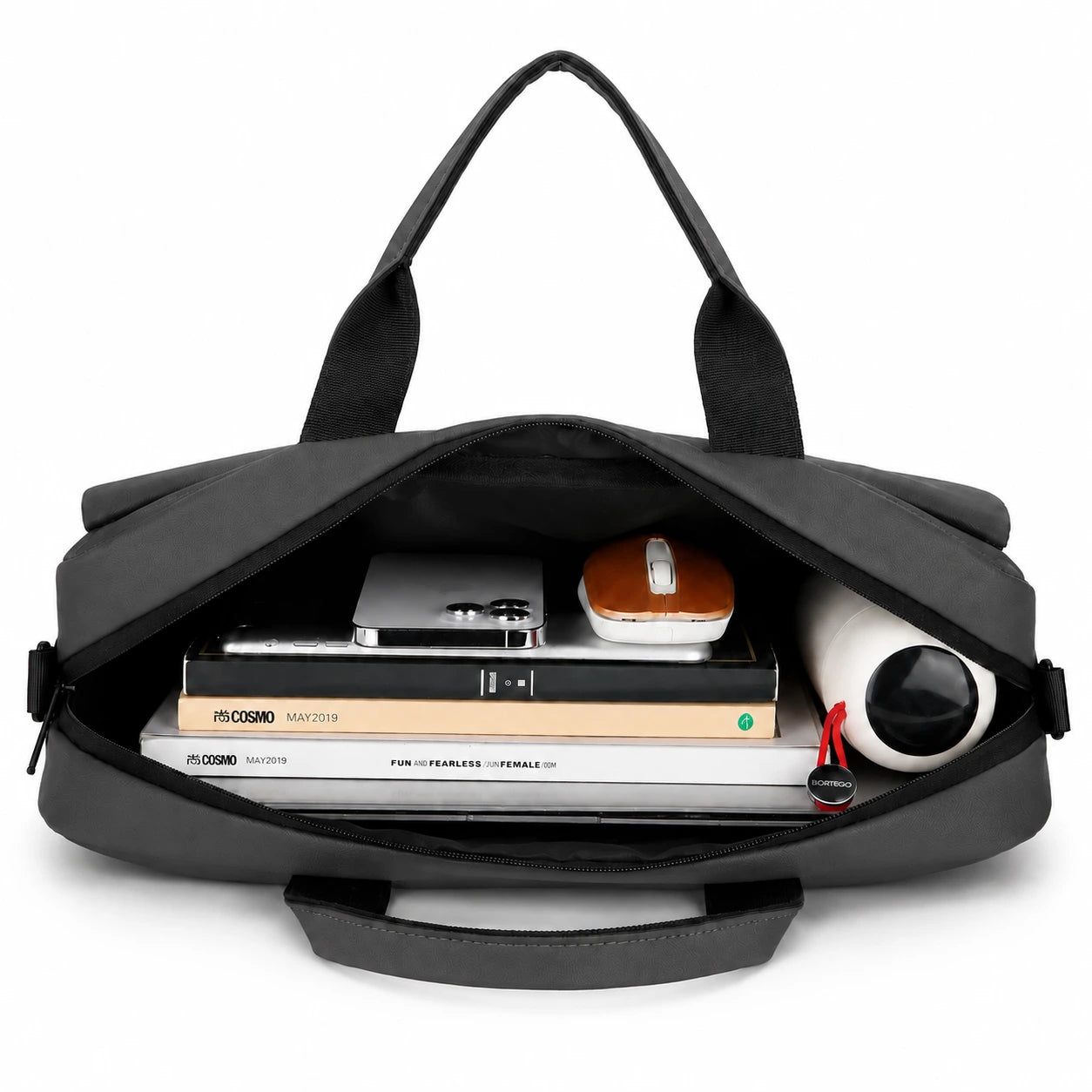 A black laptop bag shown open from above, filled with books, a tablet, a small case, and a rolled white item, on a clean white background.