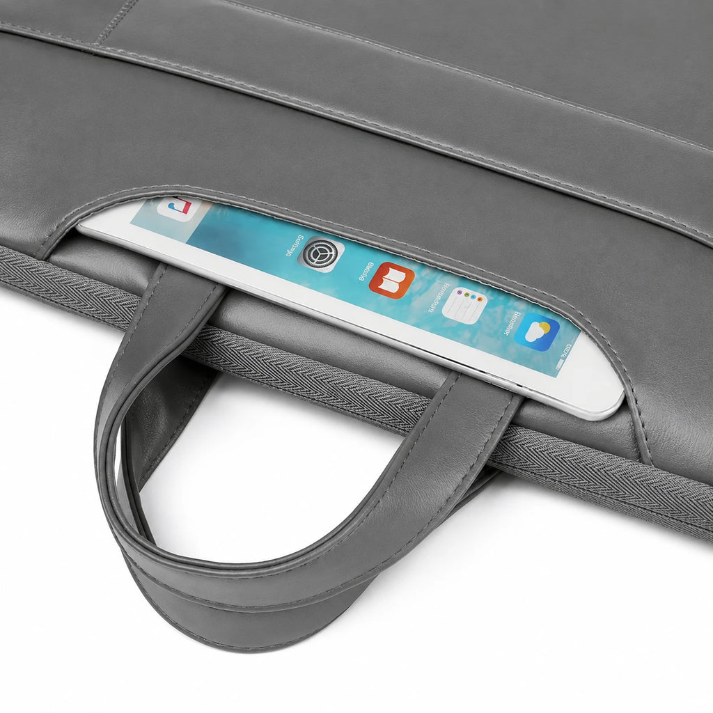 Close-up of a gray laptop sleeve with a handle and a white tablet partially tucked into a side pocket, shown on a white background.