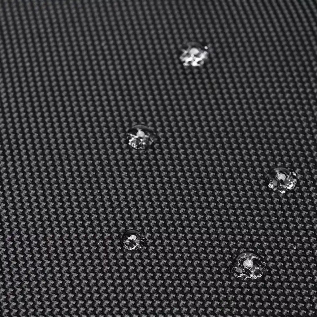Close-up of water droplets on a textured black surface