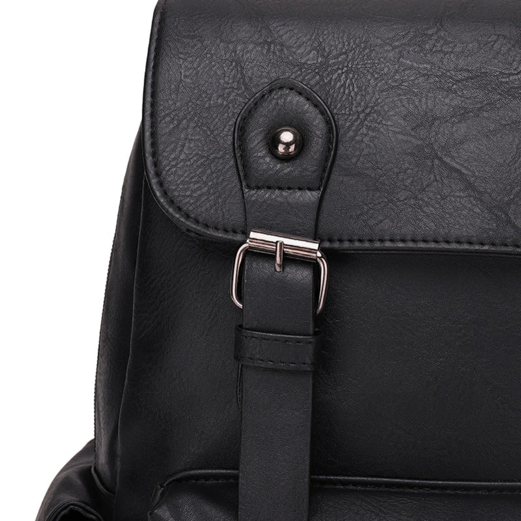 Close-up of a black backpack with a buckle on a white background