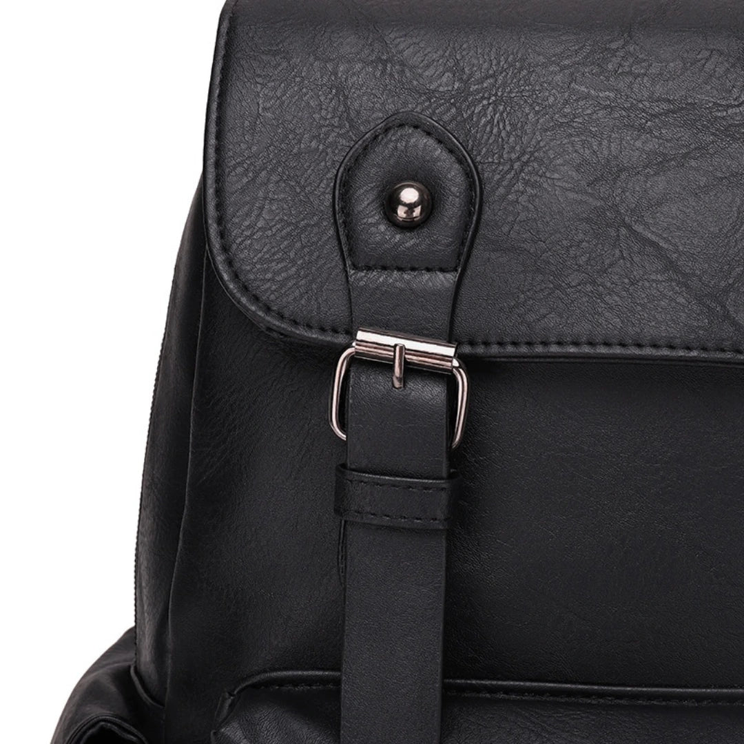 Close-up of a black backpack with a buckle on a white background
