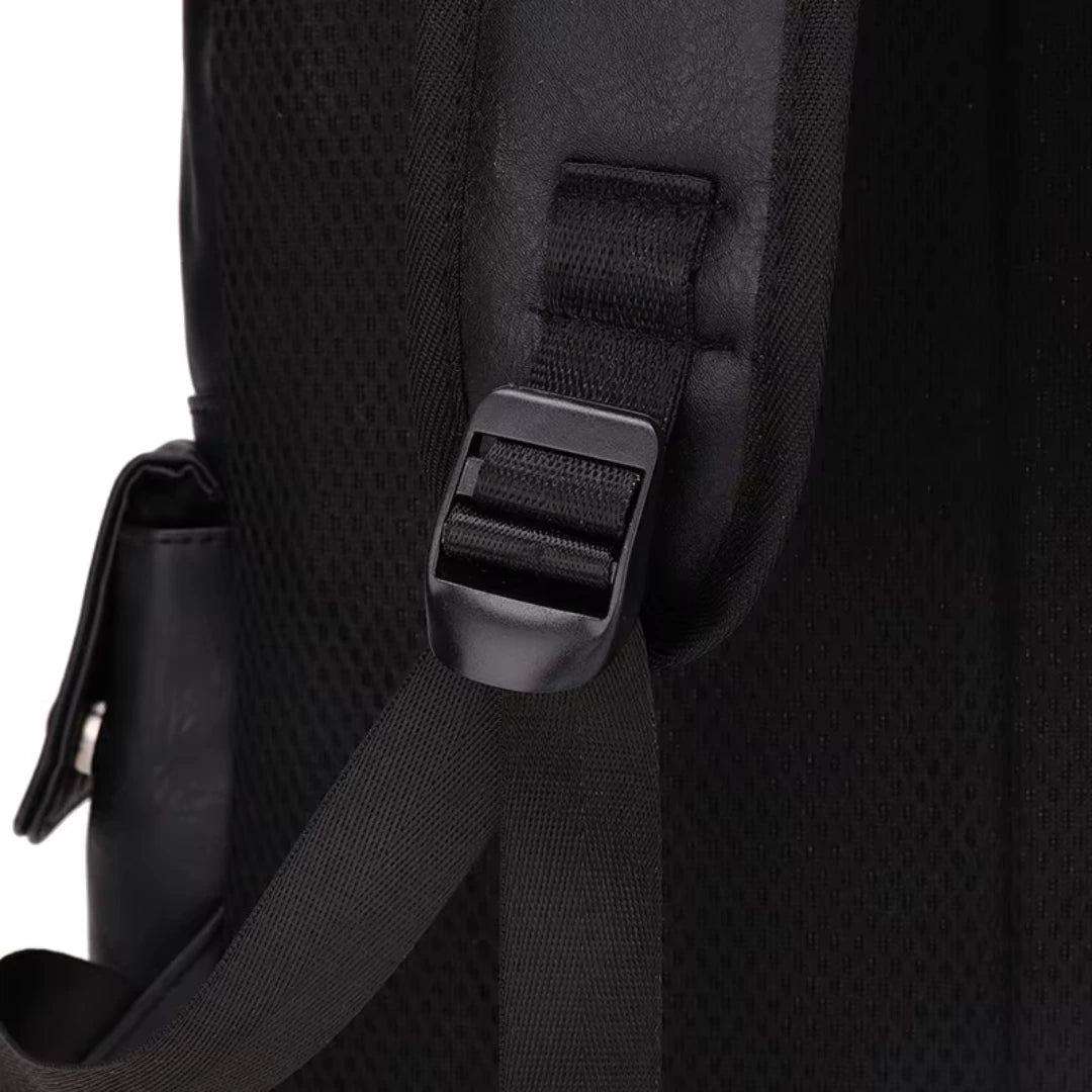 Close-up of a black backpack strap with buckle on a white background