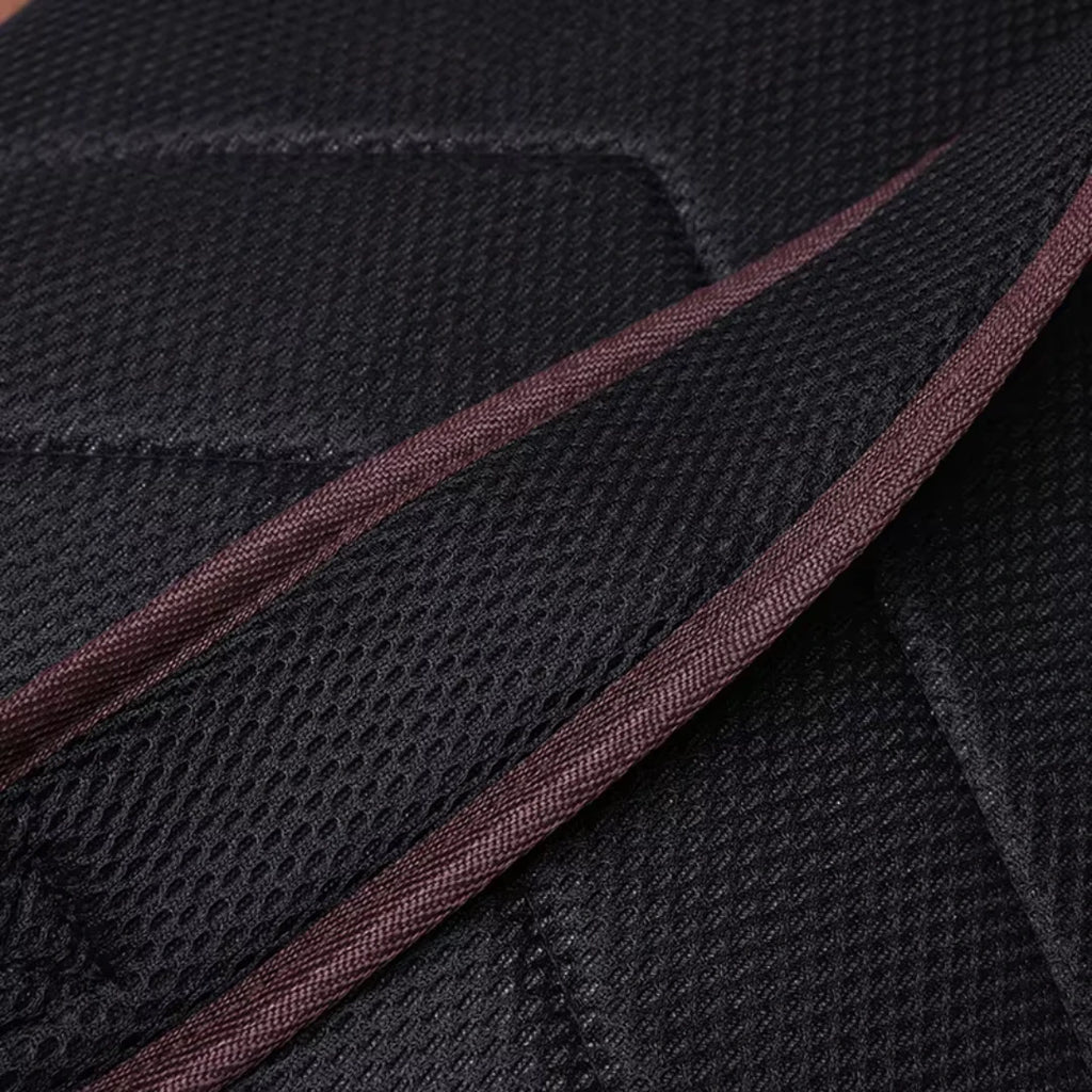 Close-up of black fabric with brown stitching