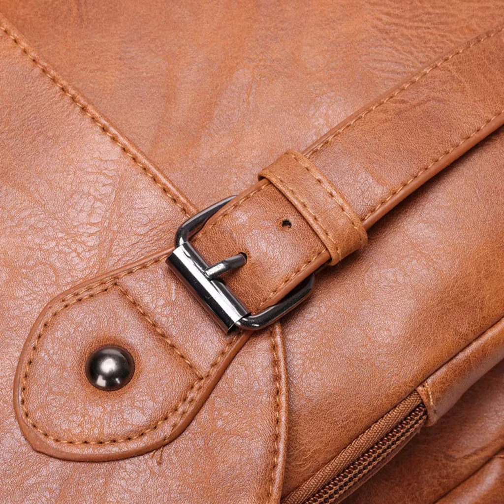 Close-up of a brown leather bag with a buckle detail
