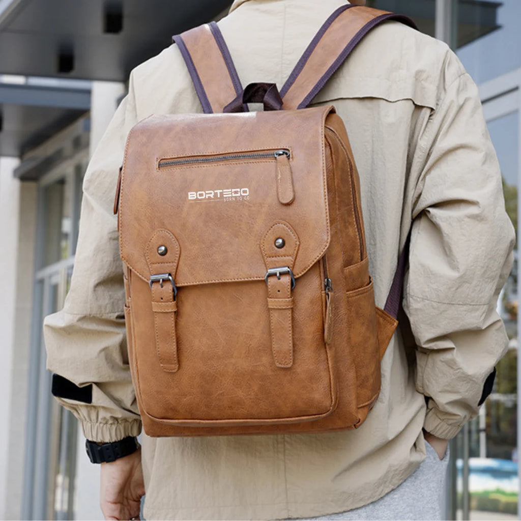 Person wearing a brown backpack with 'Bortego' branding outdoors.