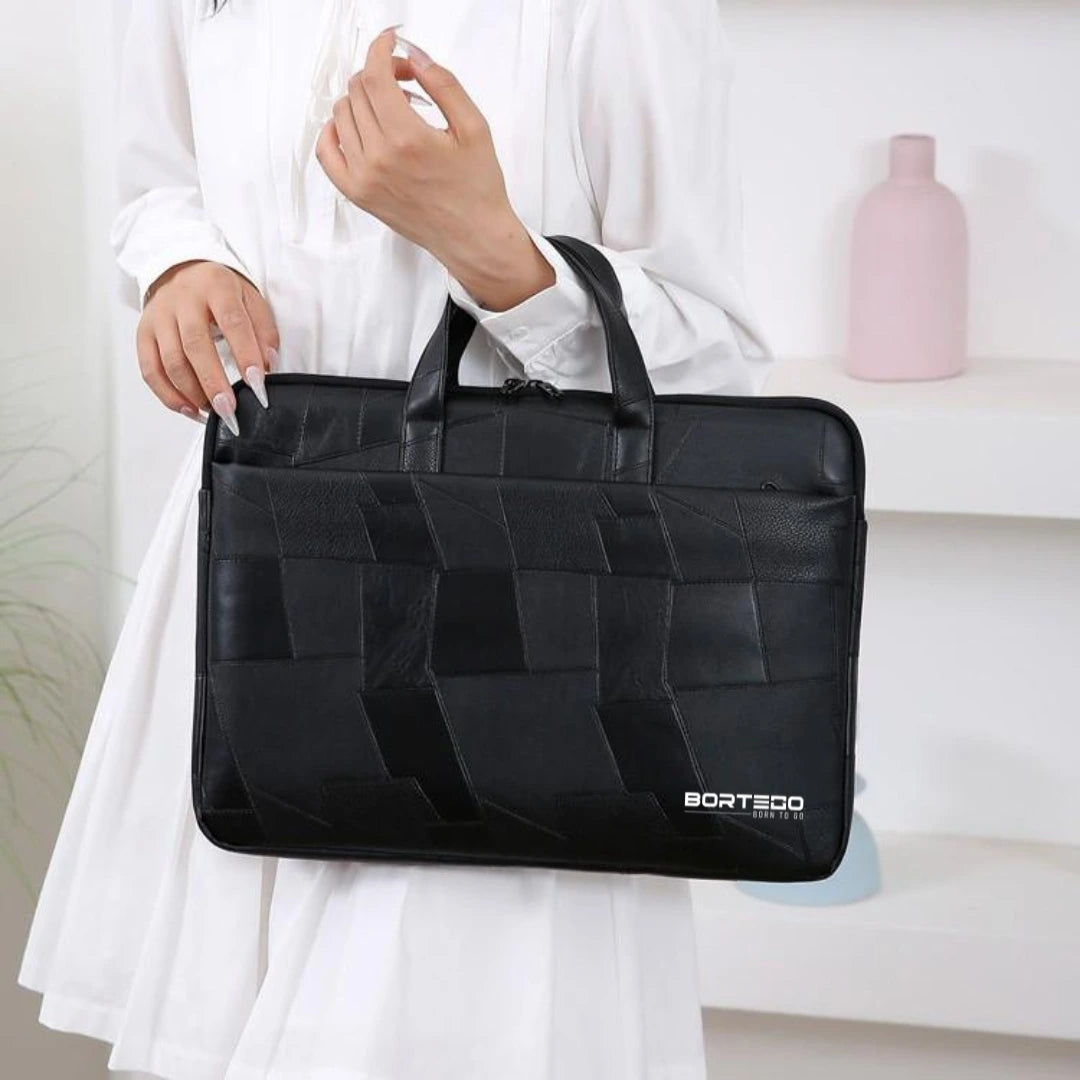 A person in a white dress holds a black woven-texture laptop bag with top handles. The bag has a geometric panel design and a visible BORTEGO logo near the bottom right.