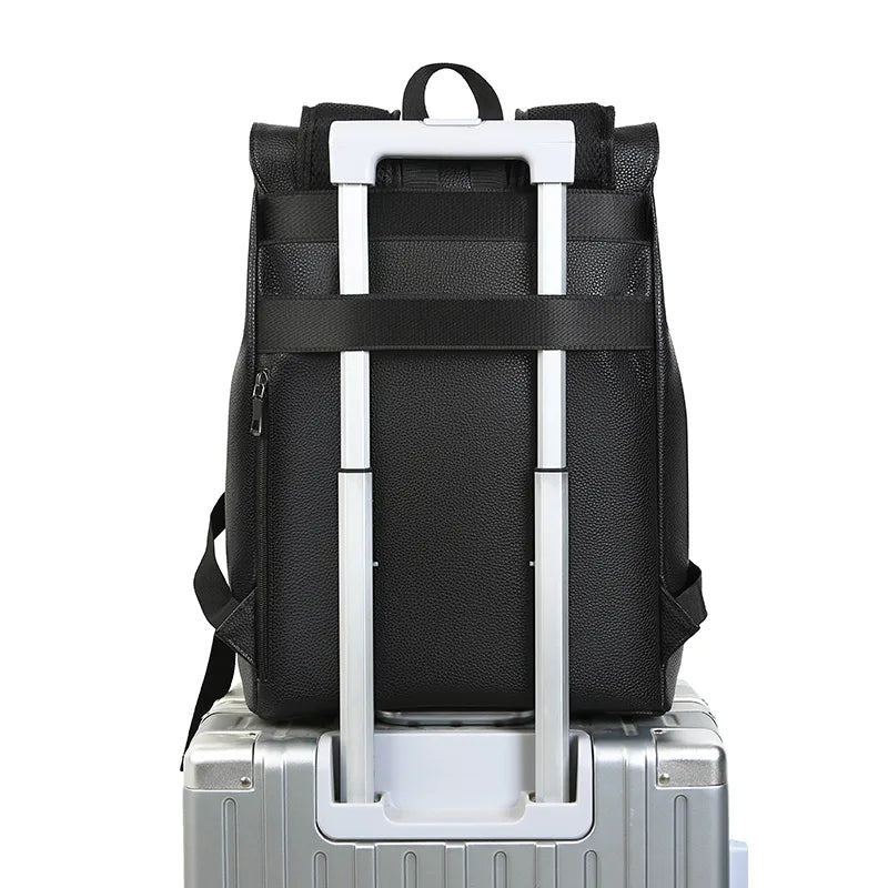 Black backpack with a white handle on a silver suitcase against a white background