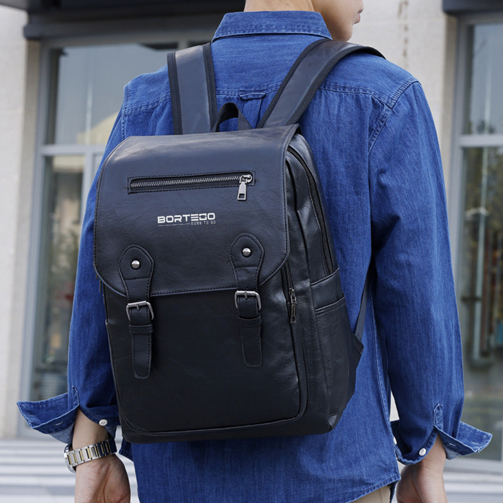 Person wearing a black backpack with 'Bortego' branding in an urban setting.