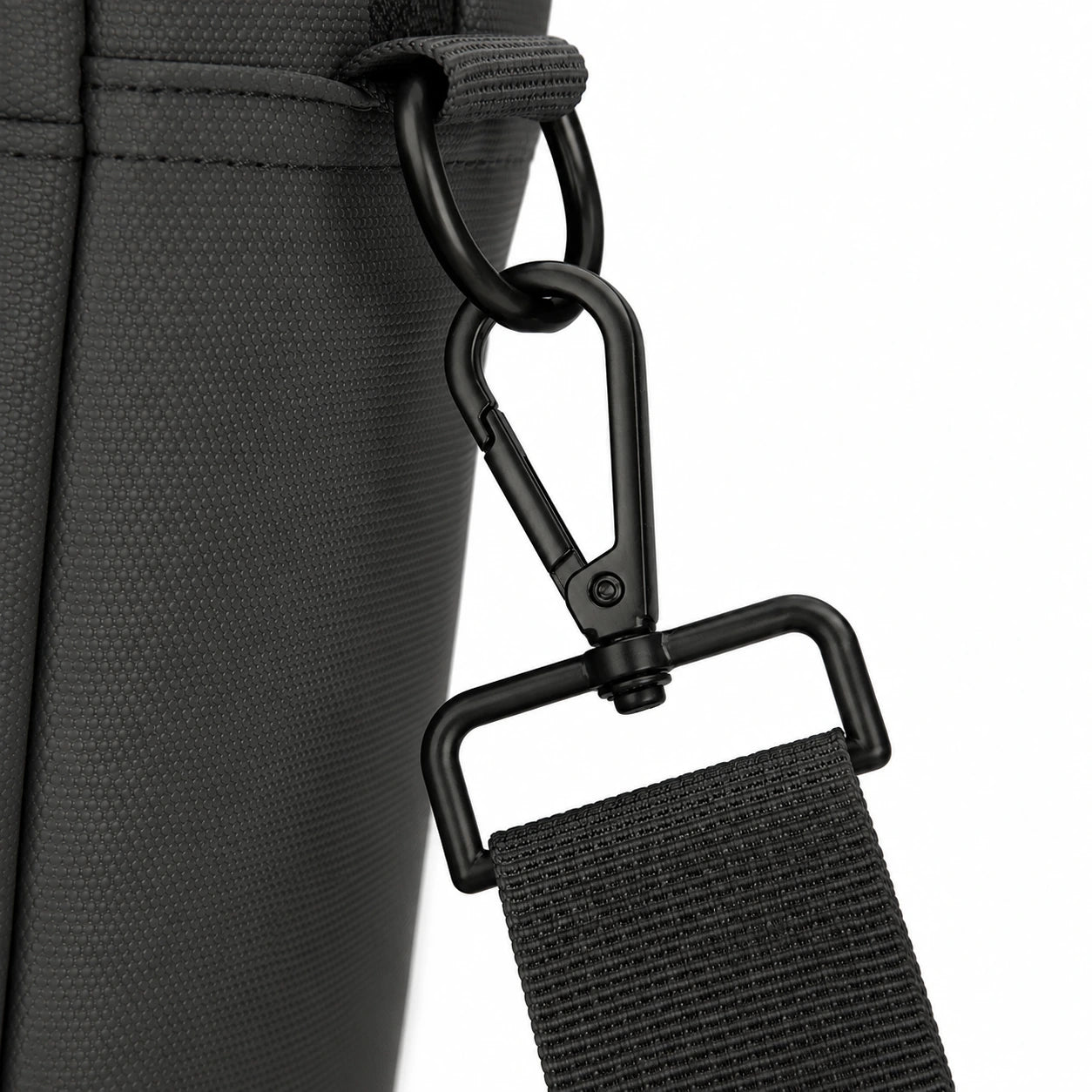 Close-up of a black textured fabric bag with a black metal carabiner and webbing strap attachment on a white background.