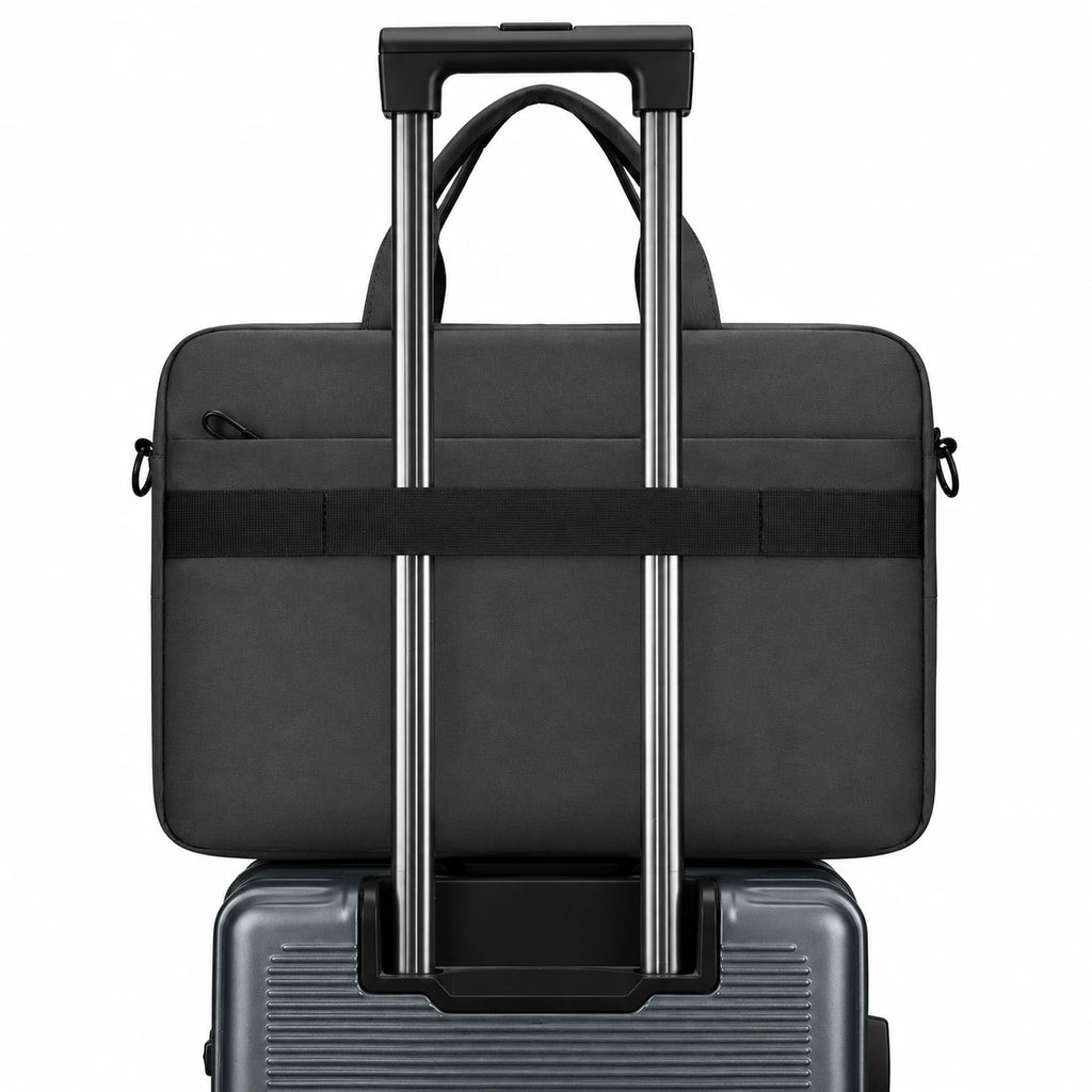 A black laptop bag with a telescoping handle and side straps, shown stacked on top of a gray rolling suitcase against a plain white background.