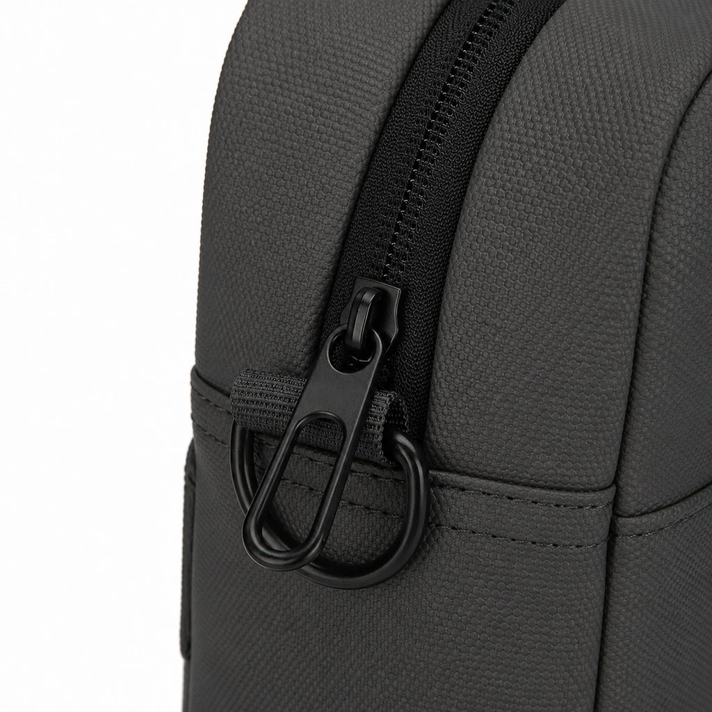 Close-up of a dark gray textured fabric bag with a black zipper and black metal carabiner ring on a white background.