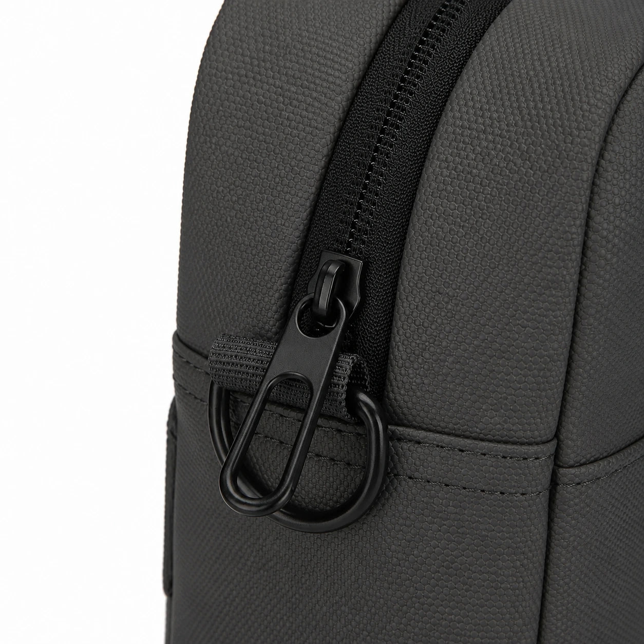 Close-up of a dark gray textured fabric bag with a black zipper and black metal carabiner ring on a white background.