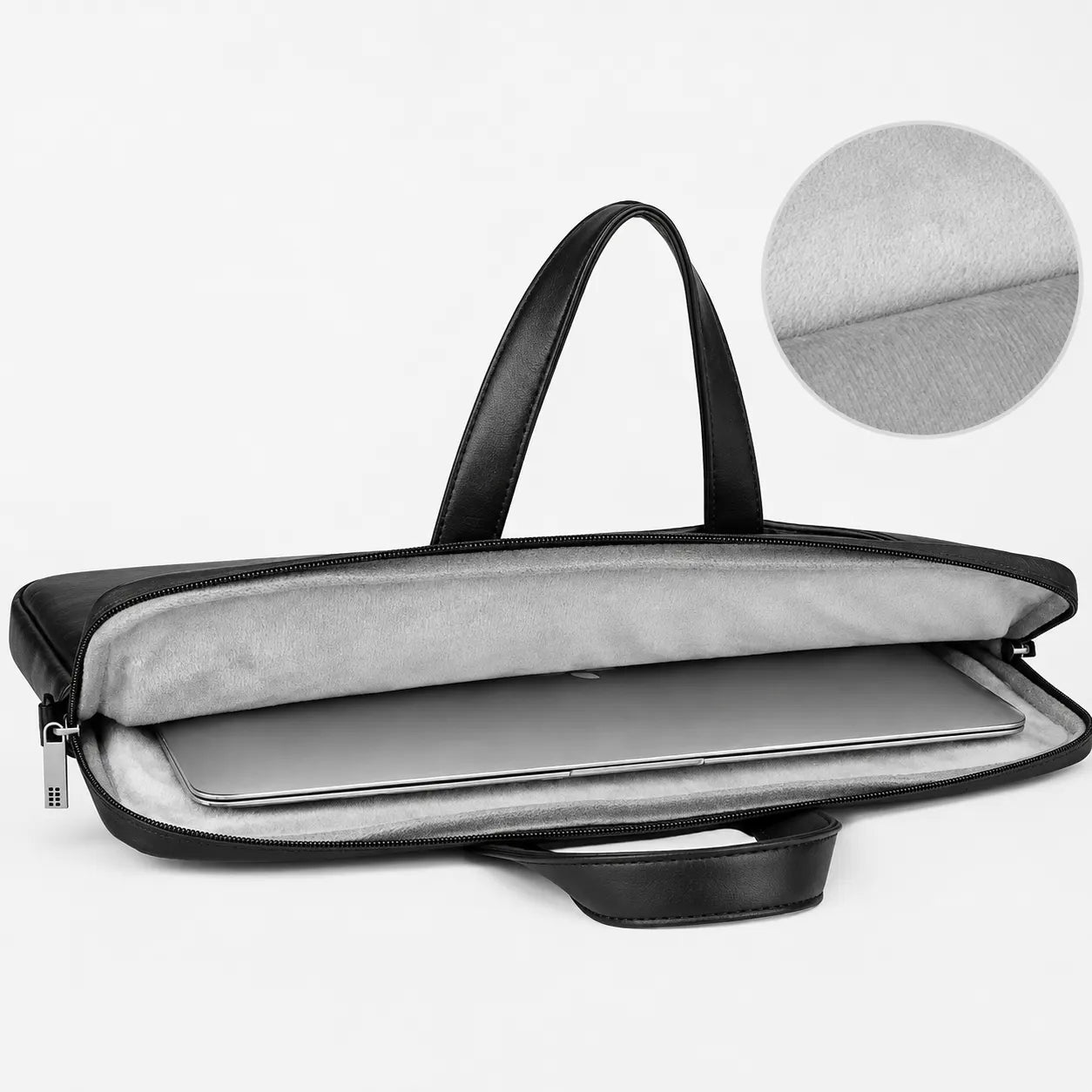 A black laptop tote bag with a light gray interior, shown open with a laptop inside. A circular inset in the upper right shows a close-up of the soft gray fabric texture.