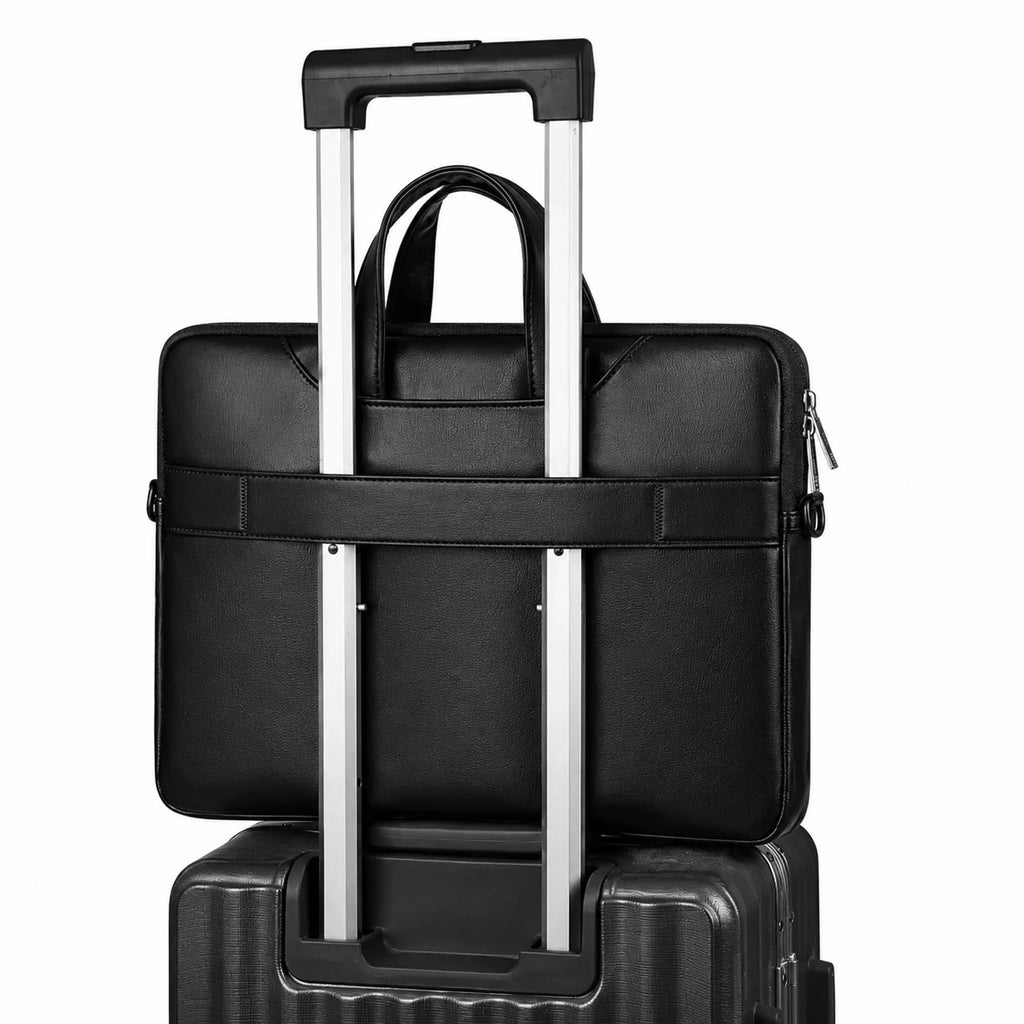 A black leather-like briefcase or laptop bag with a top handle and horizontal strap, shown with an extended silver telescoping handle resting over a dark rolling suitcase on a white background.