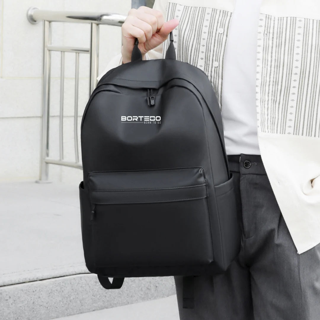 city black Bortego backpack in hand