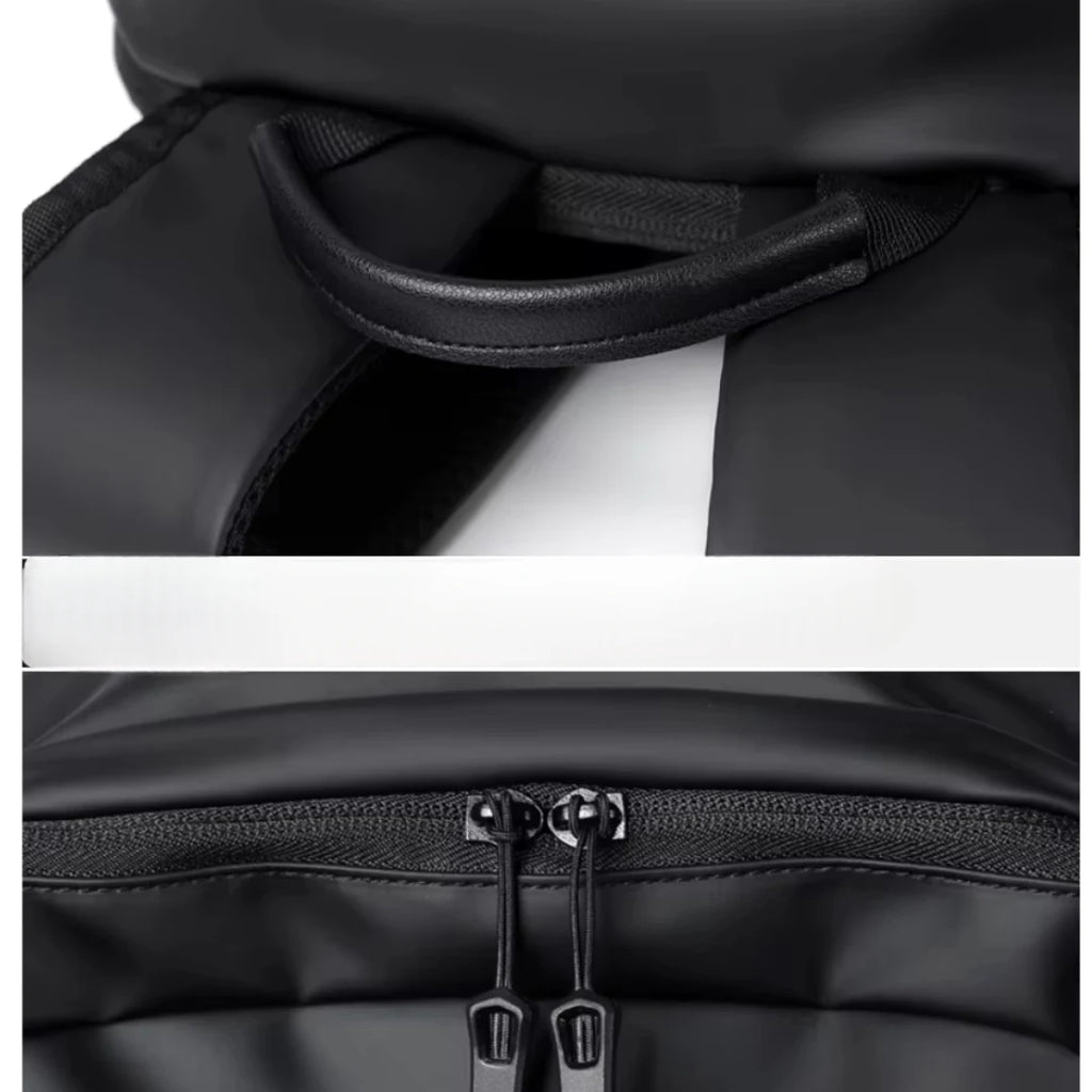 Close-up of a black backpack with a handle and zipper details on a white background