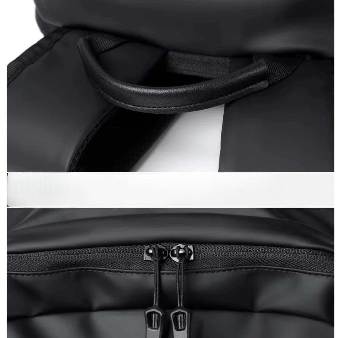 Close-up of a black backpack with a handle and zipper details on a white background
