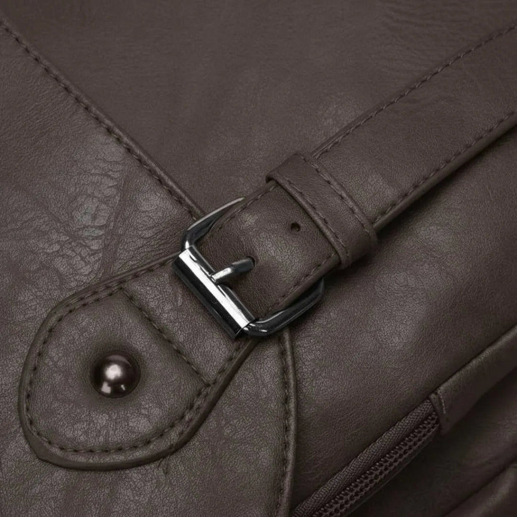 Close-up of a brown leather bag with a buckle detail