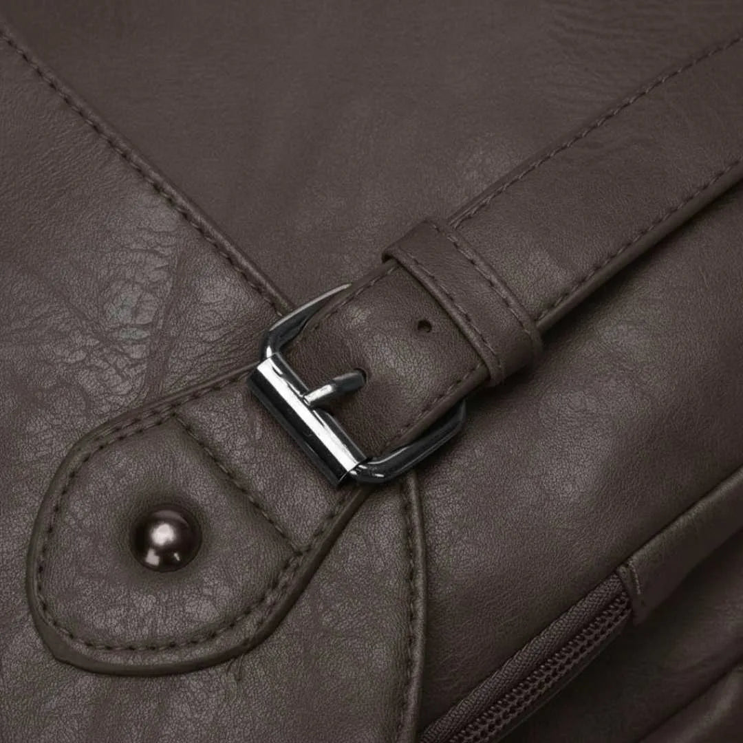 Close-up of a brown leather bag with a buckle detail