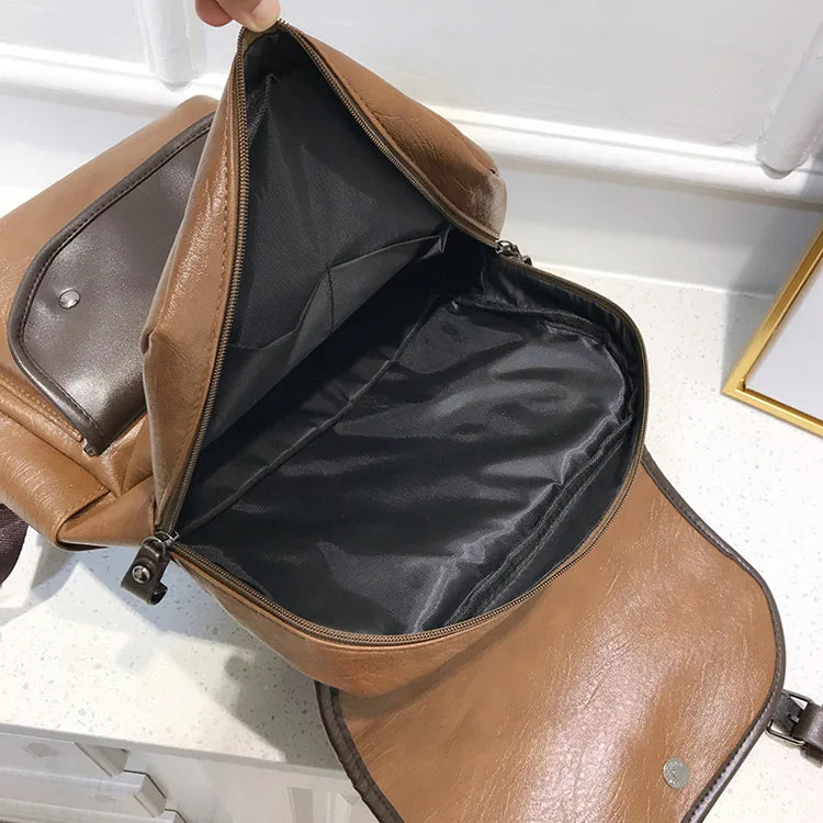 Brown leather backpack Bortego with open front compartment on a white background