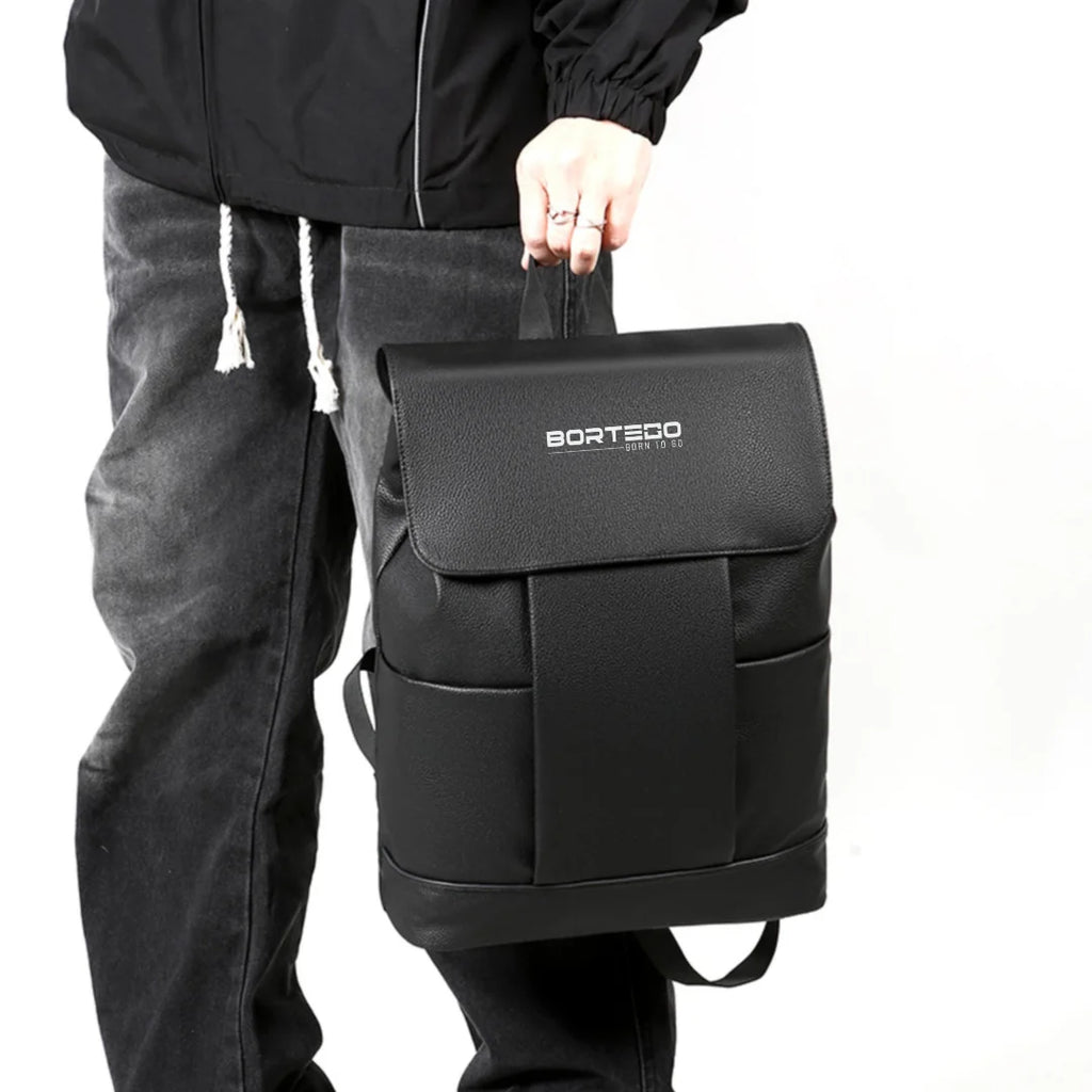 Person holding a black backpack with 'Borteco' branding on a white background