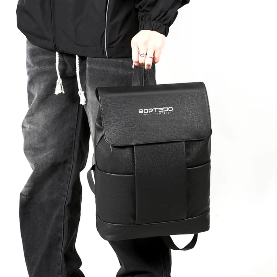 Person holding a black backpack with 'Borteco' branding on a white background
