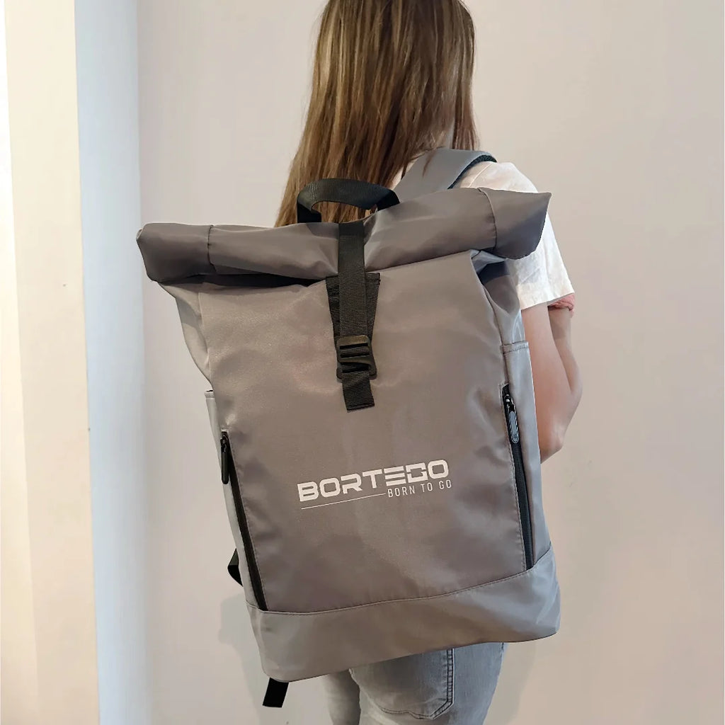 Person wearing a gray backpack with 'Bortego' branding on a plain background