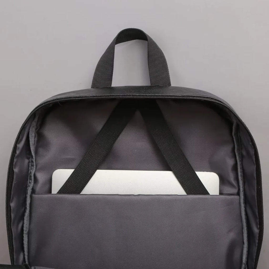 Black backpack with a white device inside on a gray background