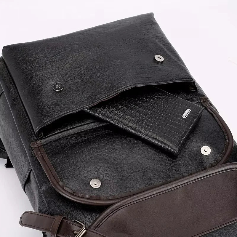 Black leather backpack with a wallet inside on a white background