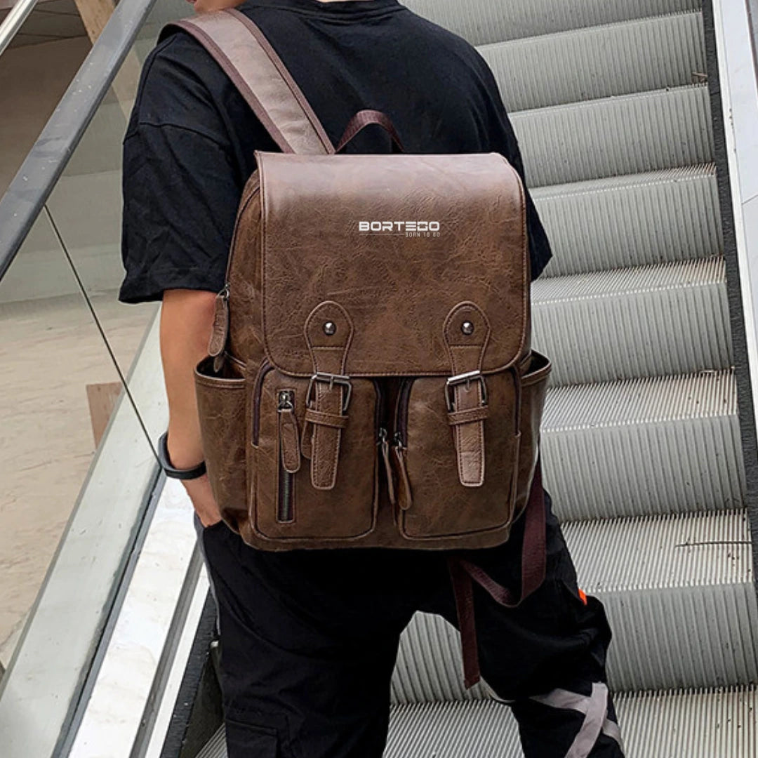 Person wearing a brown backpack with 'Bortego' branding on a staircase.