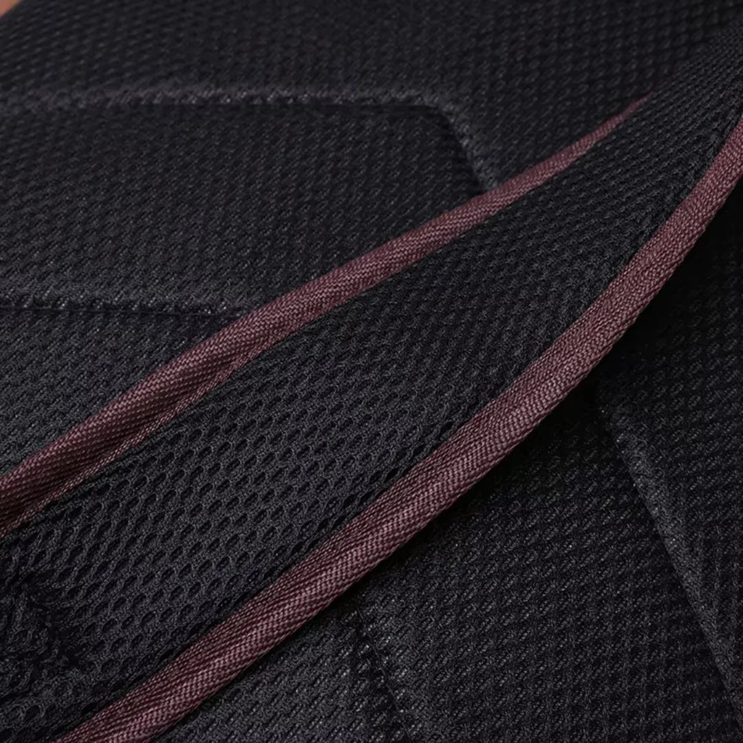 Close-up of black textured fabric with a brown stripe