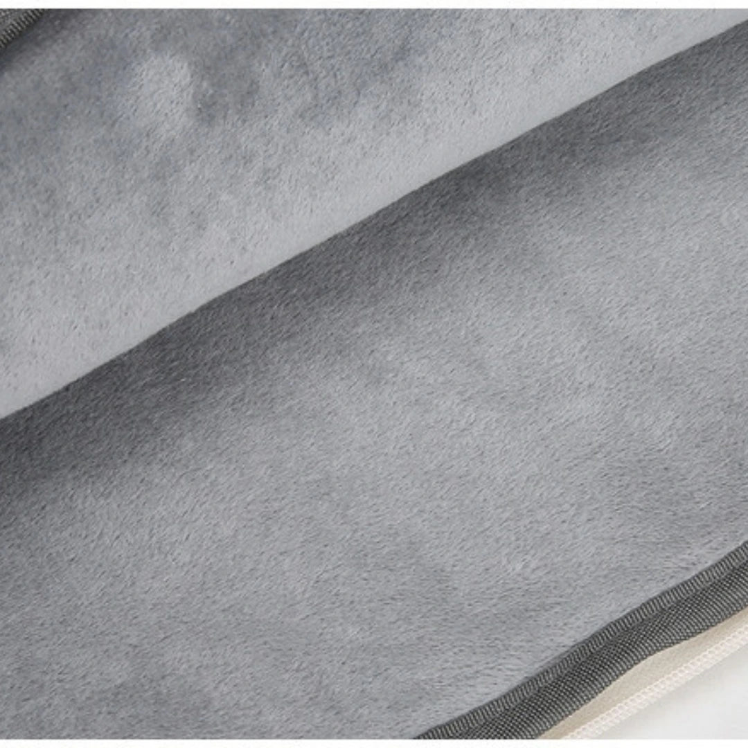 Close-up of a soft gray plush or fleece fabric surface with a ribbed dark trim along the edge.