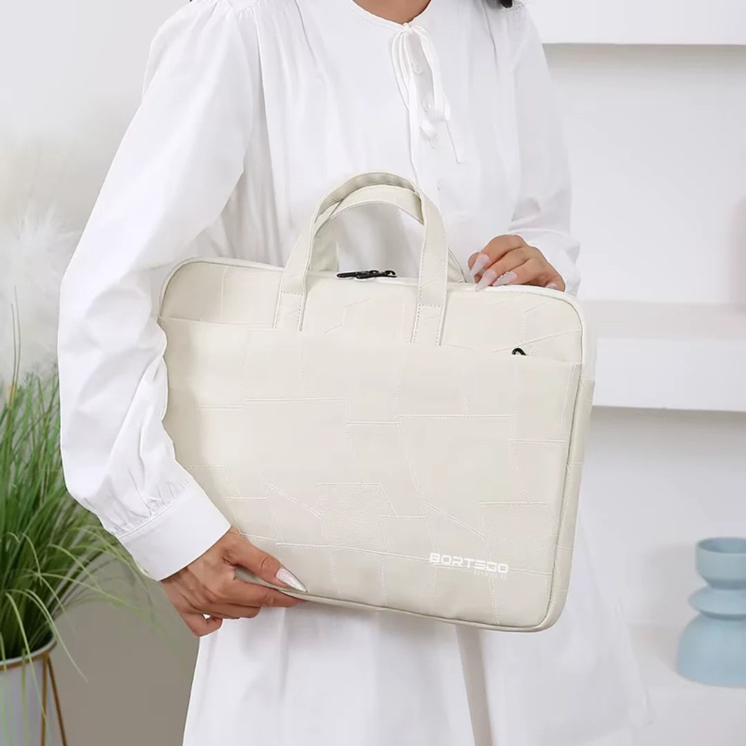 A person in a white long-sleeve top holds a light beige laptop sleeve with top handles. The sleeve has a subtle embossed grid pattern and a small white 'BORTEGO' logo near the bottom right corner.
